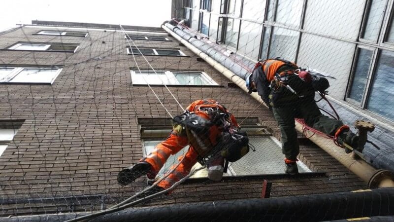 Rope access team installing netting